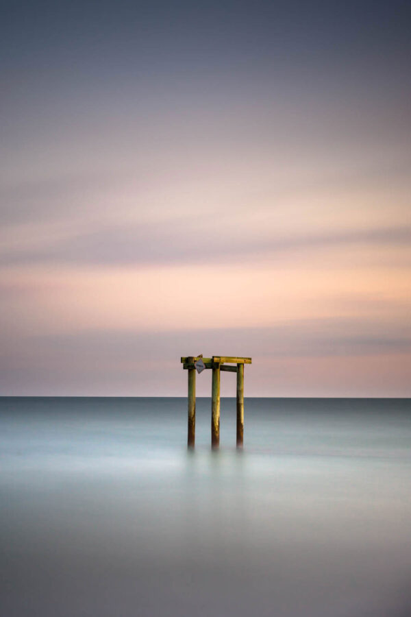 Groin during sunset, a minimalist view created by a long exposure photography technique by Ivo Kerssemakerws